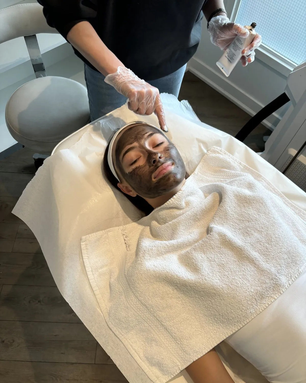 Our aesthetician applying the carbon mask to a client at our clinic in Thornhill